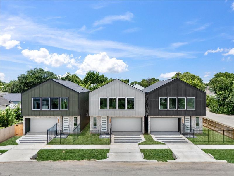 Each home boasts a sleek, symmetrical façade complemented by fully fenced-in front yards, contemporary landscaping, and custom concrete + gravel driveways leading to spacious 2-car garages.
