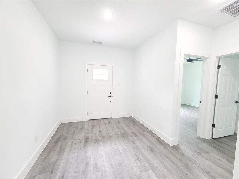 Foyer entrance featuring light wood-style flooring and baseboards Foyer entrance featuring light wood-style flooring and baseboards