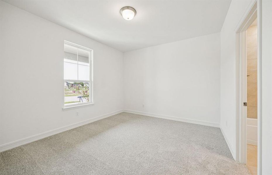 Spacious secondary bedroom features ample closet space *Real home pictured