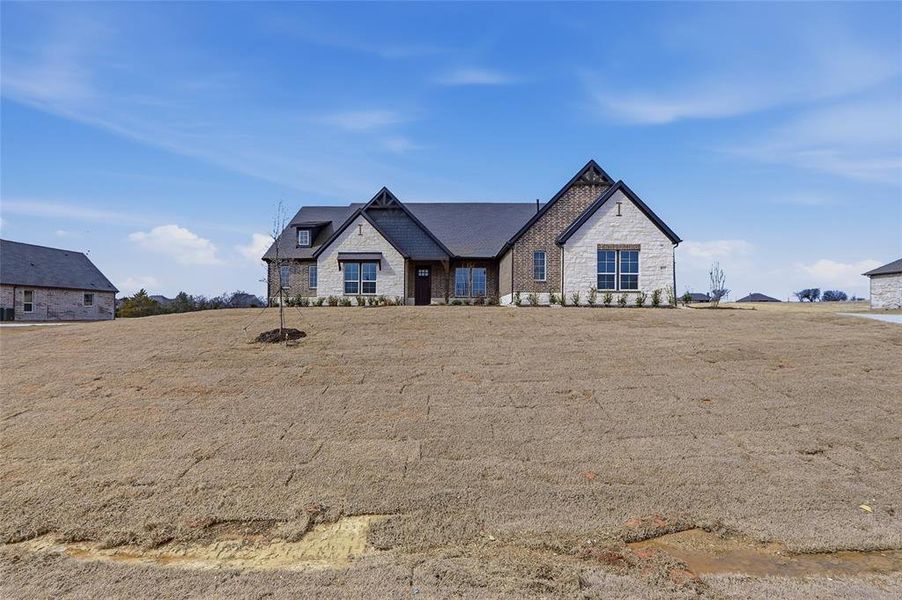 View of front facade featuring stone siding