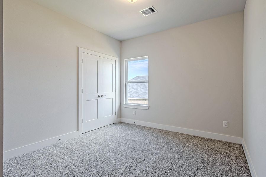 Tucked just beyond the bathroom, this secondary bedroom offers a quiet corner retreat with plenty of closet space and morning sunshine. Tucked just beyond the bathroom, this secondary bedroom offers a quiet corner retreat with plenty of closet space and morning sunshine.