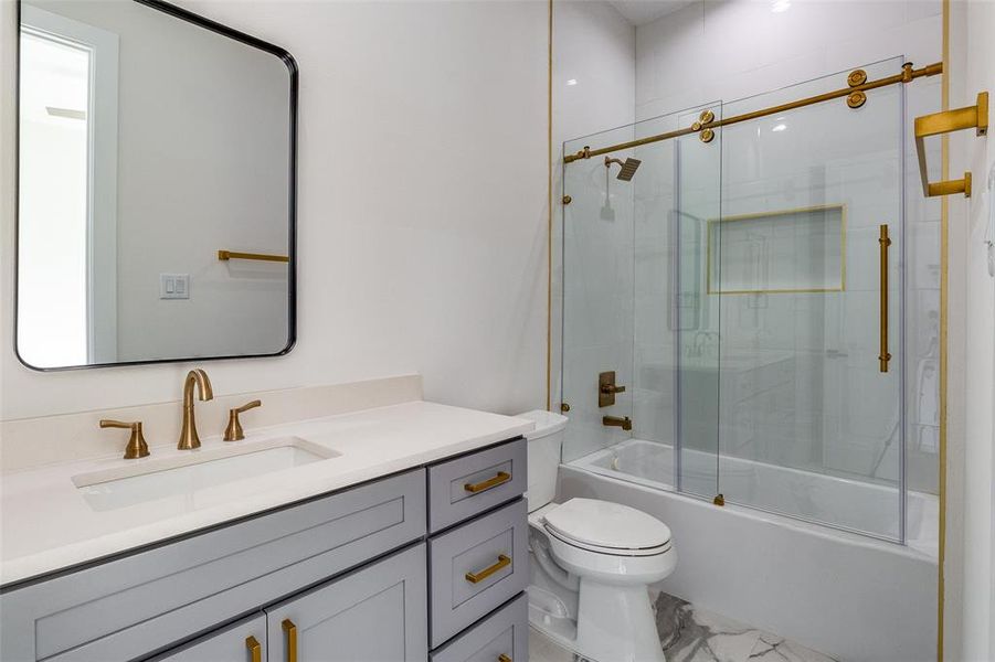 Full bathroom with tile patterned flooring, vanity, toilet, and enclosed tub / shower combo