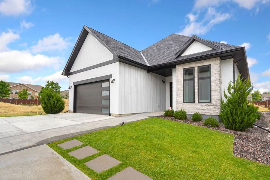 Front exterior of a new home in Pelican Shores at Water Valley, Windsor, CO, highlighting curb appeal (Image 1). Front exterior of a new home in Pelican Shores at Water Valley, Windsor, CO, highlighting curb appeal (Image 1).