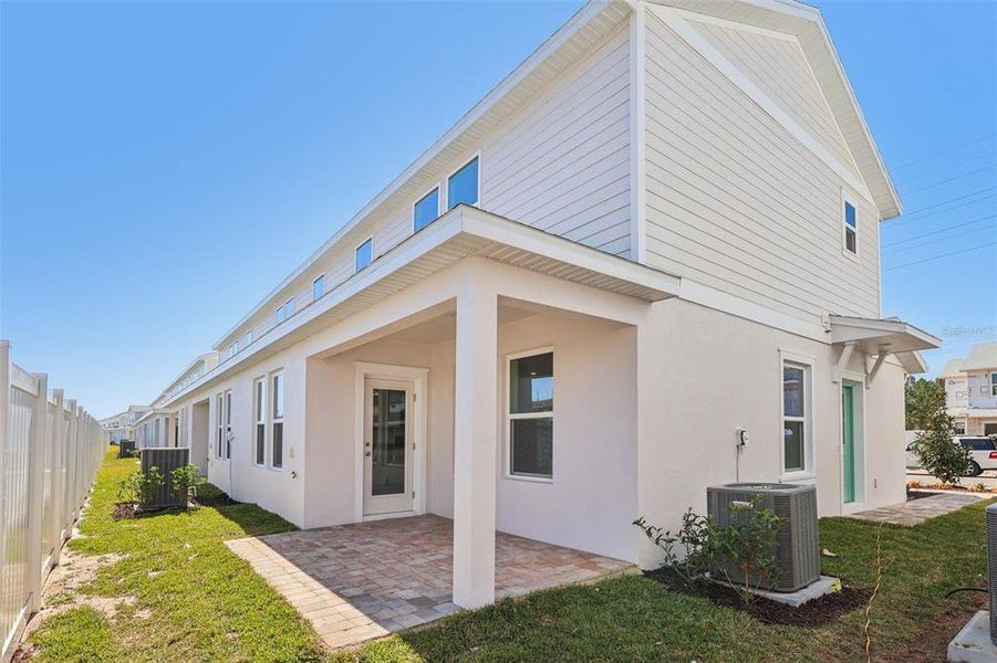 Exterior details and patio area of a home in Cyrene at Harmony, St. Cloud (Image 21).