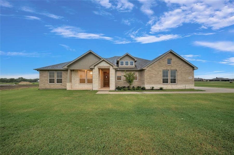 Craftsman inspired home featuring a front lawn, brick siding, and roof with shingles Craftsman inspired home featuring a front lawn, brick siding, and roof with shingles