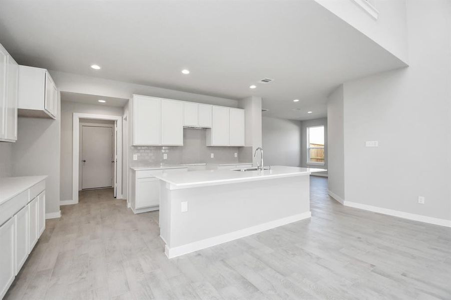 Discover another perspective of this stunning kitchen.  Sample photo of completed home with similar plan. As built color and selections may vary.