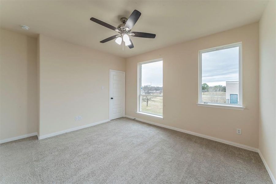 Unfurnished room featuring ceiling fan and light colored carpet