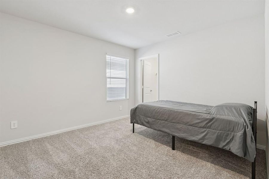 Bedroom featuring carpet floors and baseboards