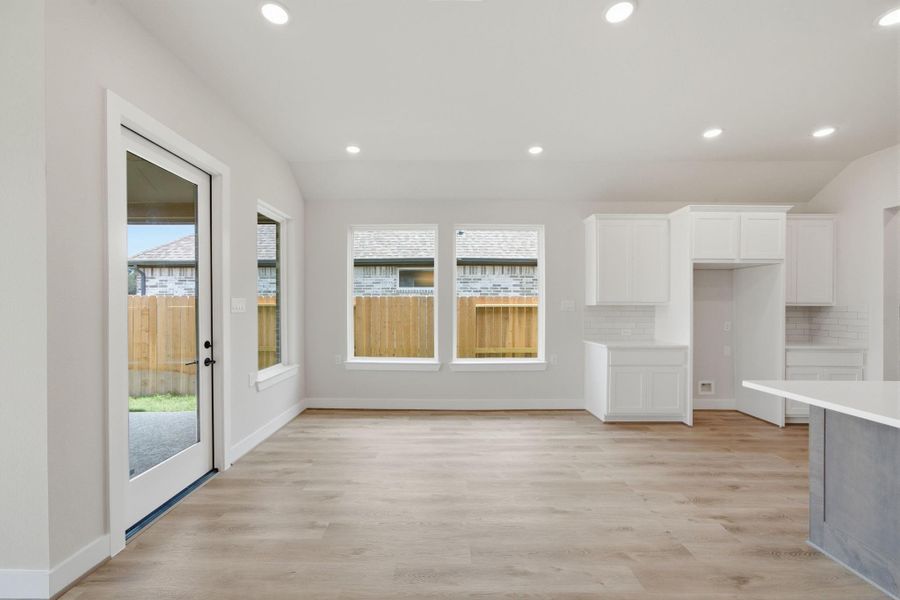Bright café area with abundant natural light and easy access to the covered patio for seamless indoor-outdoor living.