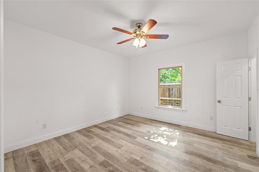 Spare room featuring light wood-type flooring and ceiling fan