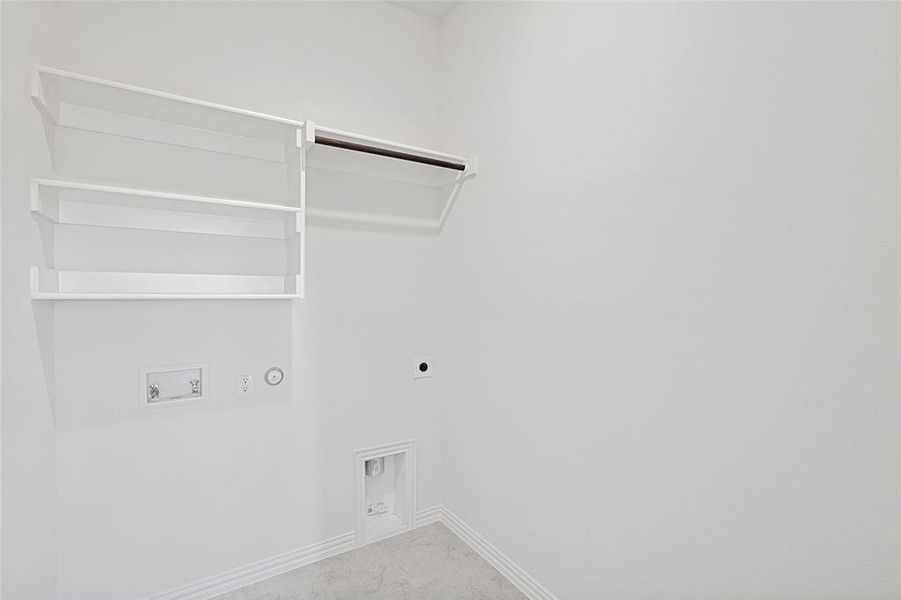 Laundry area with hookup for an electric dryer, gas dryer hookup, and hookup for a washing machine