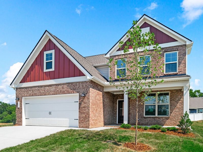 Front exterior of a new home in Woods Crossing, Gallatin, TN, highlighting curb appeal (Image 2). Front exterior of a new home in Woods Crossing, Gallatin, TN, highlighting curb appeal (Image 2).