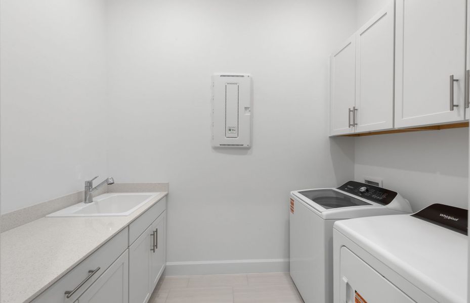 Spacious laundry room featuring a sink and additional storage space