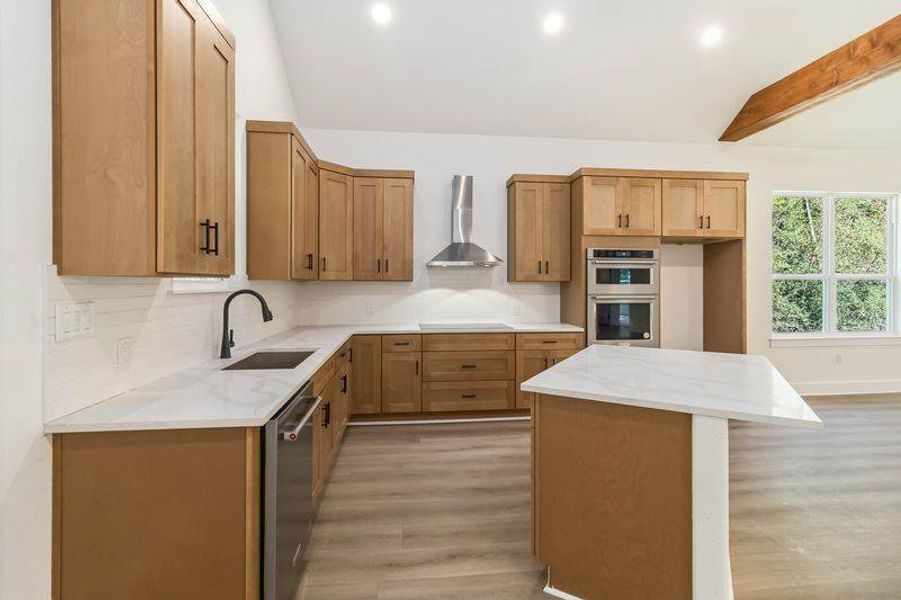 Kitchen featuring a kitchen island, light stone countertops, backsplash and Kitchen Aid stainless steel appliances