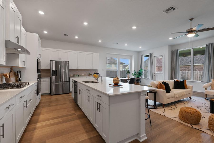 A contemporary open-concept layout unites the kitchen and living areas, offering effortless daily living.