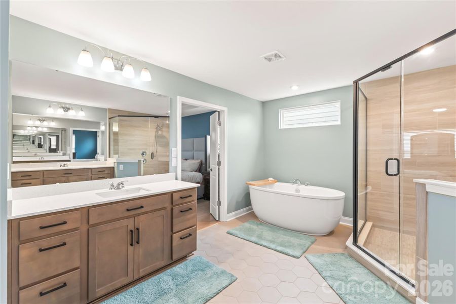 Deep soaking tub to relax away the cares of the day AND separate dual vanities and large corner shower