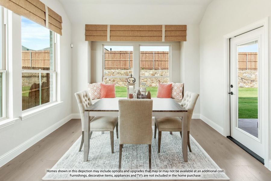 Bright dining area with wood table, upholstered chairs, bench seating, and large windows overlooking a backyard Bright dining area with wood table, upholstered chairs, bench seating, and large windows overlooking a backyard
