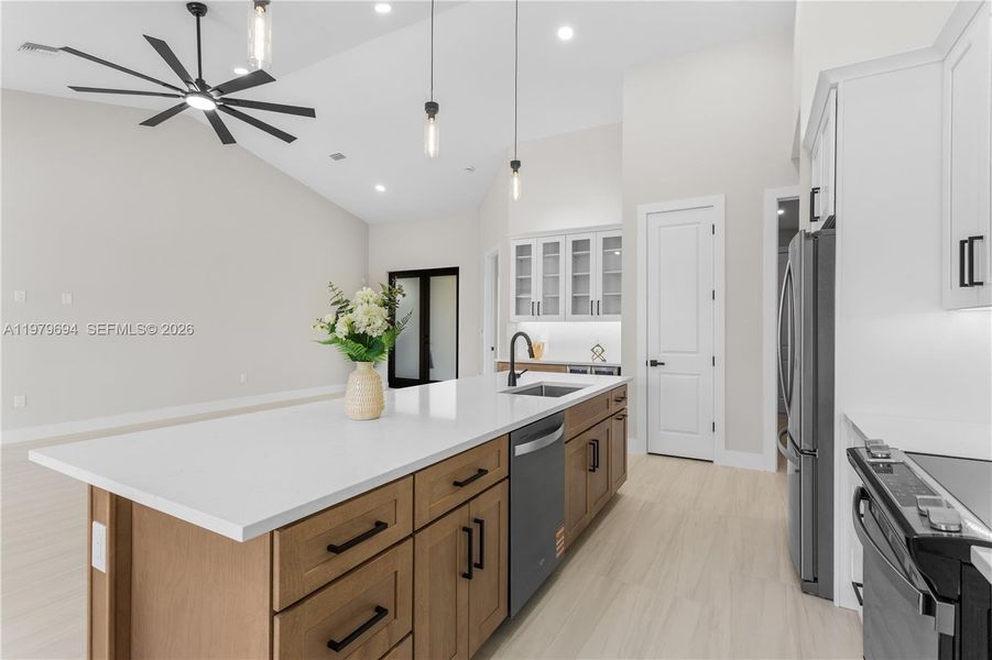 GORGEOUS CHEF'S KITCHEN w/ SPACIOUS QUARTS COUNTERTOP ISLAND w/ undermount LARGE SINK & SLEEK MATTE-BLACK gooseneck FAUCET. GORGEOUS CHEF'S KITCHEN w/ SPACIOUS QUARTS COUNTERTOP ISLAND w/ undermount LARGE SINK & SLEEK MATTE-BLACK gooseneck FAUCET.
