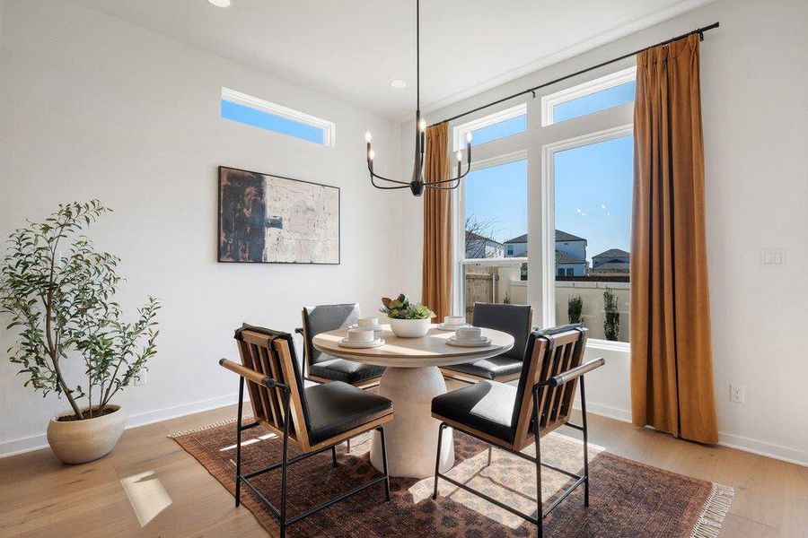 Dining area featuring abundant natural light from large windows and a high transom window