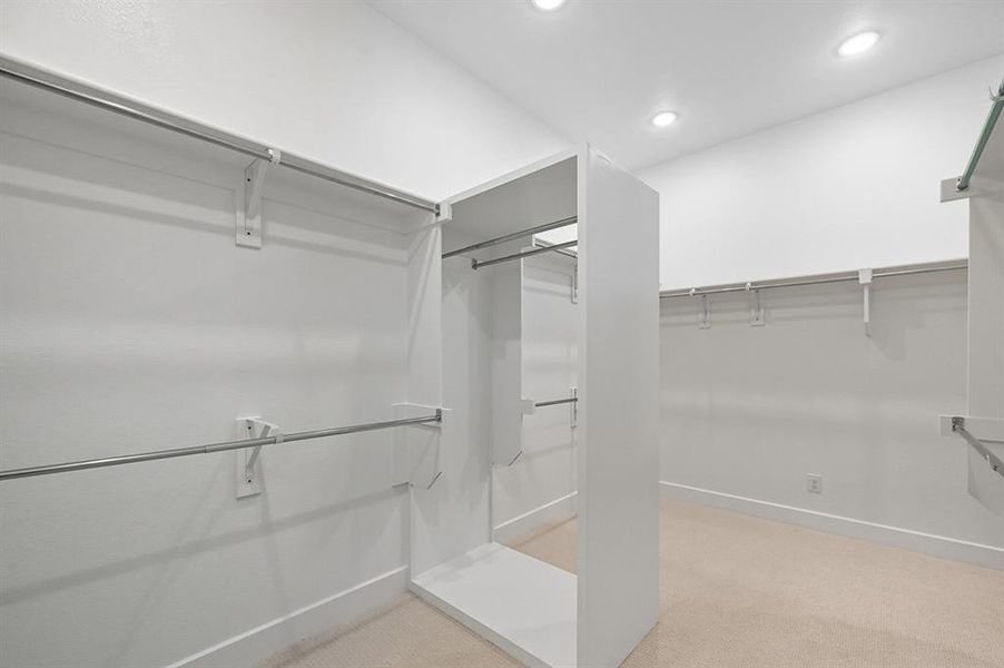 Walk in closet with light colored carpet Walk in closet with light colored carpet