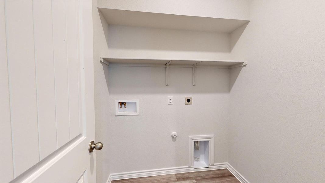 Laundry room with hookup for a gas dryer, hookup for a washing machine, light wood-style flooring, and hookup for an electric dryer