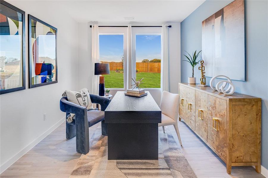 Dining area featuring light wood-type flooring and baseboards