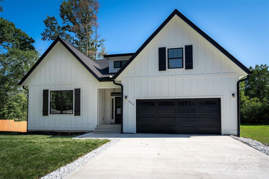 Front exterior of a new home in , Hendersonville, NC, highlighting curb appeal (Image 1).