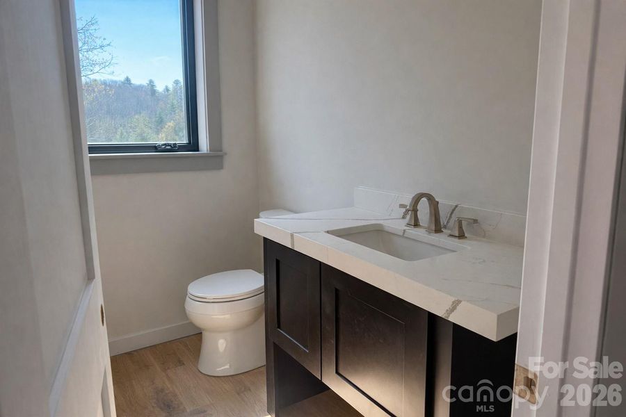 Downstairs half bath with premium finishes.