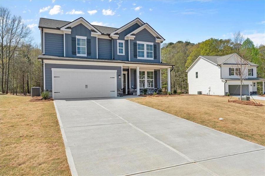 Front exterior of a new home in Ellington Farms, Statham, GA, highlighting curb appeal (Image 2). Front exterior of a new home in Ellington Farms, Statham, GA, highlighting curb appeal (Image 2).