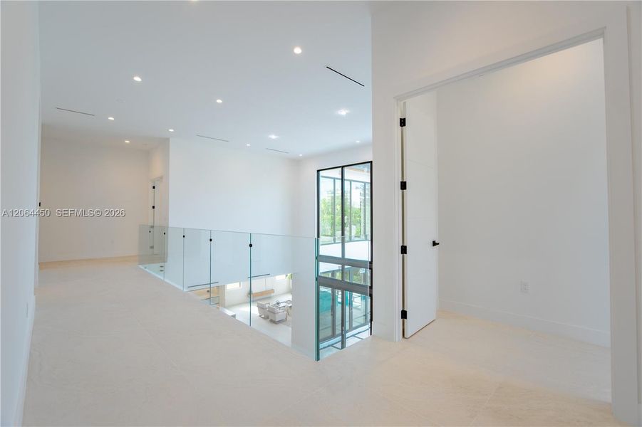 Staircase landing with glass railing