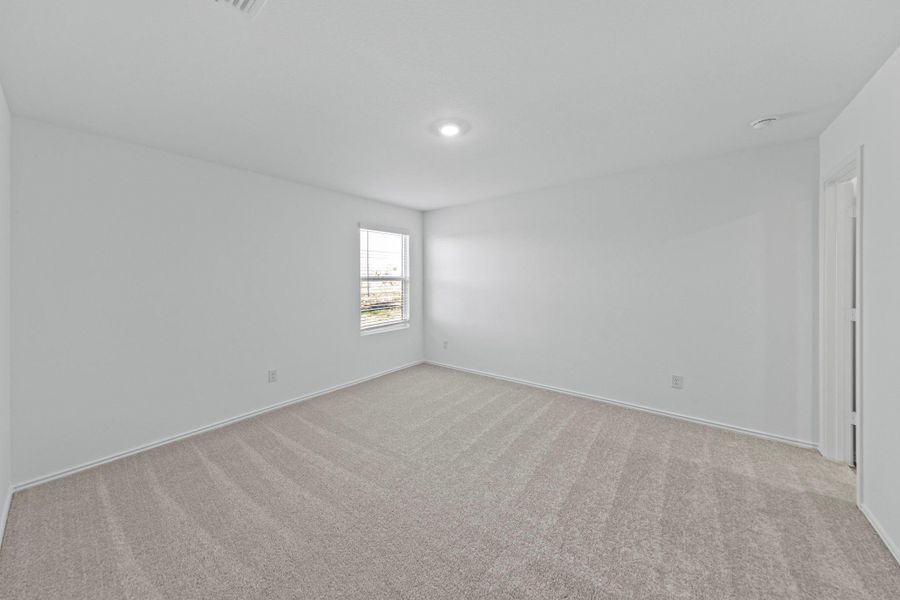 Empty room with light carpet and baseboards Empty room with light carpet and baseboards