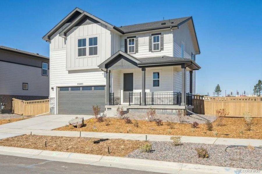 Front exterior of a new home in The Haven Collection at Windler, Aurora, CO, highlighting curb appeal (Image 2). Front exterior of a new home in The Haven Collection at Windler, Aurora, CO, highlighting curb appeal (Image 2).