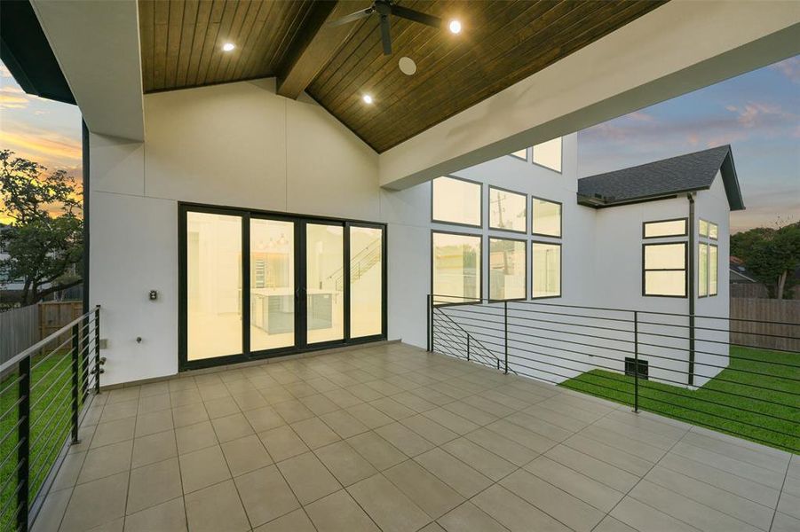 The outdoor living is enjoyable under this extended covered patio area that features tongue and groove Cathedral ceiling, built-in speakers and ceiling fan. Fully plumbed for a summer kitchen, the builder will work with the buyer  to complete that space to the buyer's specifications.