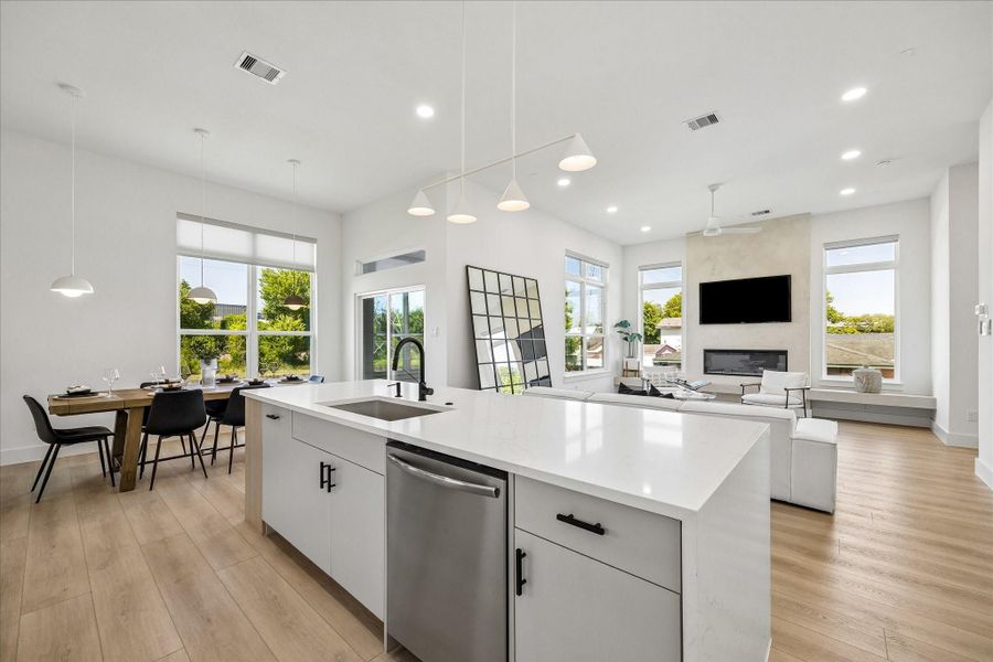 A dramatic waterfall island anchors the space, complemented by custom cabinetry that extends to the ceiling for a refined, built in look.