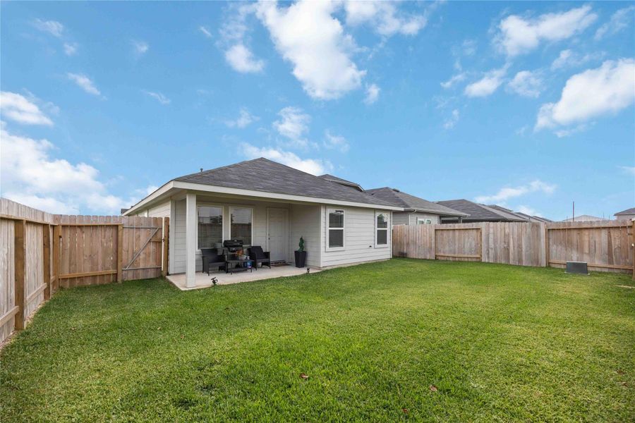 This photo shows a spacious backyard with a