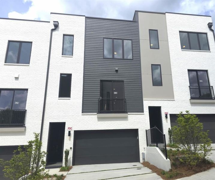 Front exterior of a new home in Overlook at Moda, Decatur, GA, highlighting curb appeal (Image 1). Front exterior of a new home in Overlook at Moda, Decatur, GA, highlighting curb appeal (Image 1).