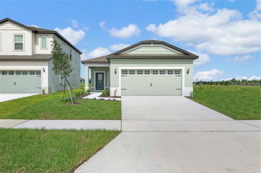 Front exterior of a new home in Gum Lake Preserve, Lake Alfred, FL, highlighting curb appeal (Image 15).