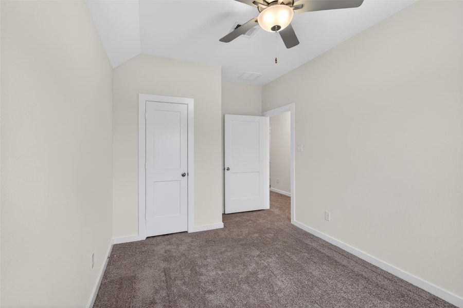 Comfortable secondary bedroom featuring plush carpeting, soft neutral tones, and a clean, versatile layout ideal for guests, family, or a home office. Comfortable secondary bedroom featuring plush carpeting, soft neutral tones, and a clean, versatile layout ideal for guests, family, or a home office.