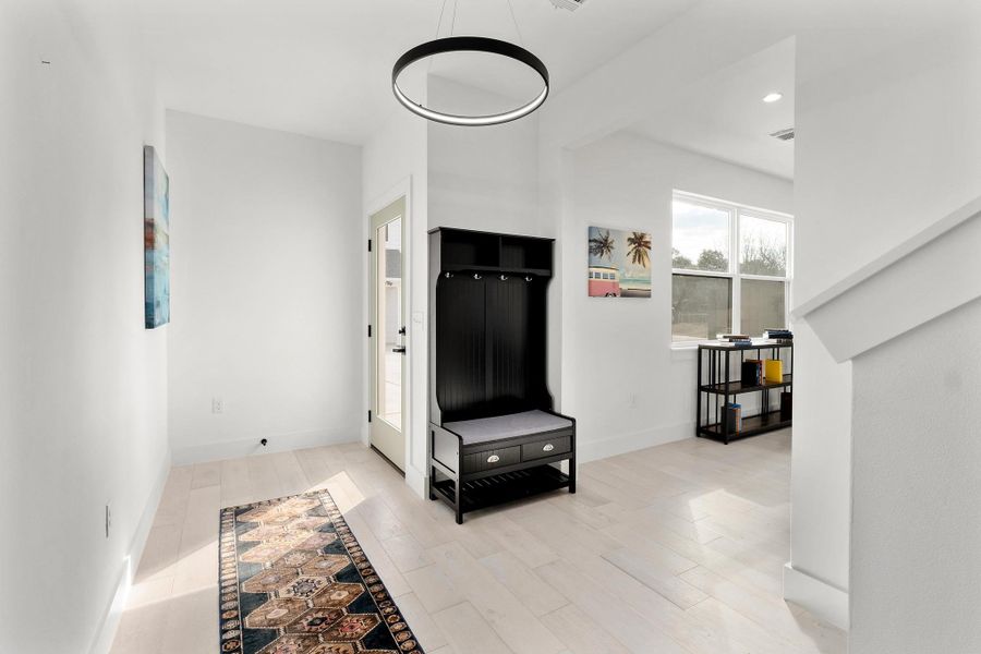 Entrance foyer with light wood-type flooring and recessed lighting