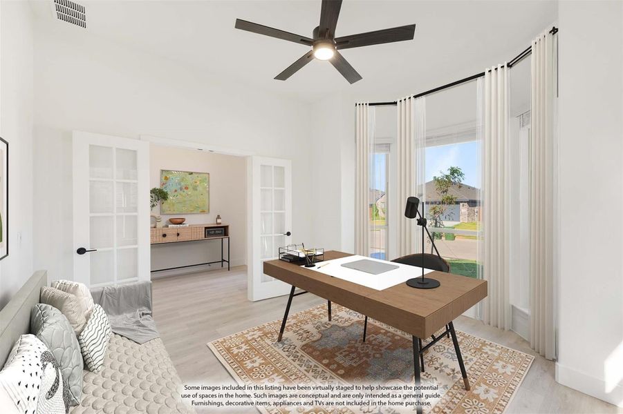 Home office with wood desk, ceiling fan, French doors, and large windows with natural light Home office with wood desk, ceiling fan, French doors, and large windows with natural light