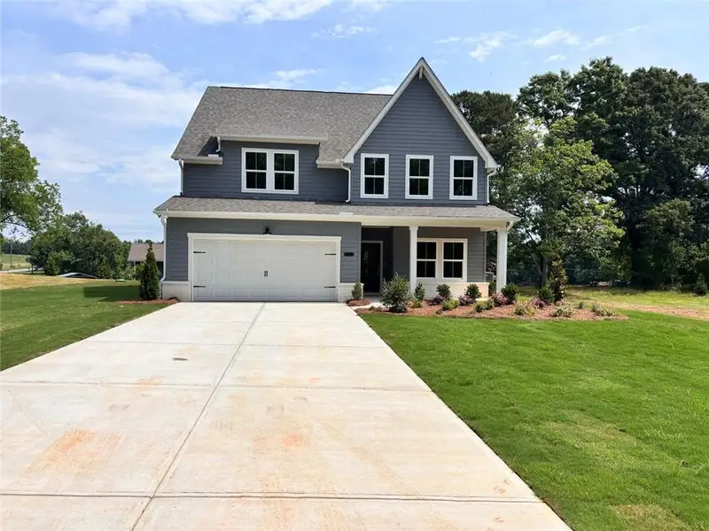 Front exterior of a new home in , Cumming, GA, highlighting curb appeal (Image 2). Front exterior of a new home in , Cumming, GA, highlighting curb appeal (Image 2).
