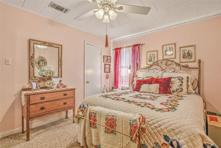 Bedroom featuring light pink walls and a textured ceiling Bedroom featuring light pink walls and a textured ceiling