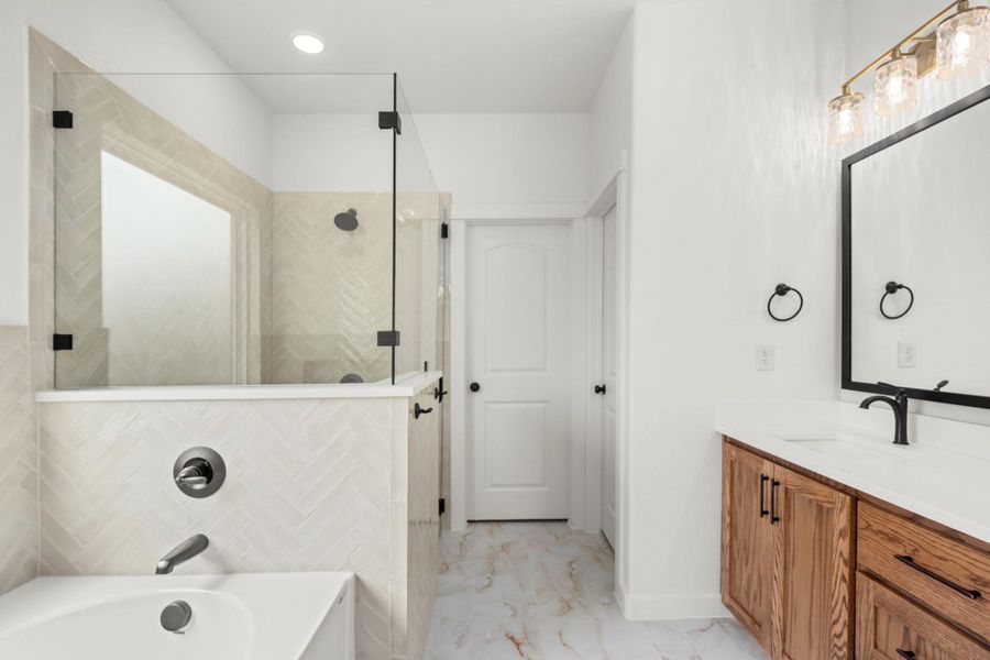 A well-appointed bath features a spacious glass-enclosed shower alongside a deep soaking tub. A well-appointed bath features a spacious glass-enclosed shower alongside a deep soaking tub.