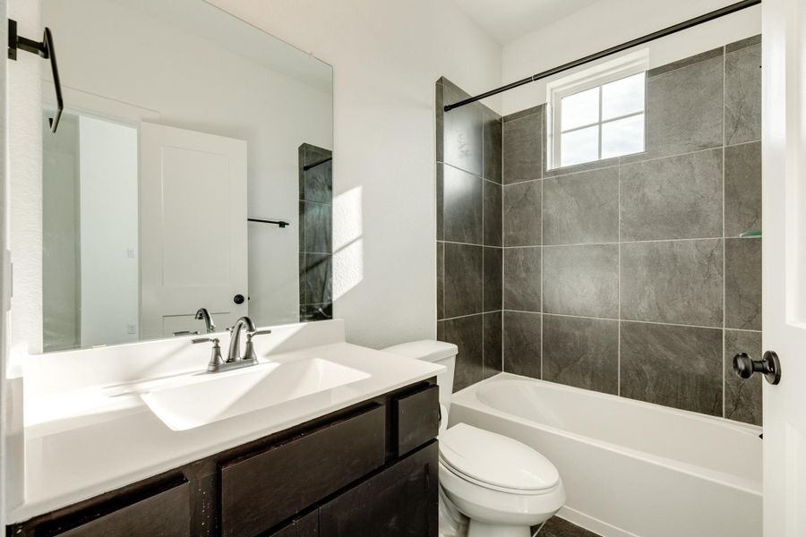 Jack and Jill bath with a tub/shower combination.