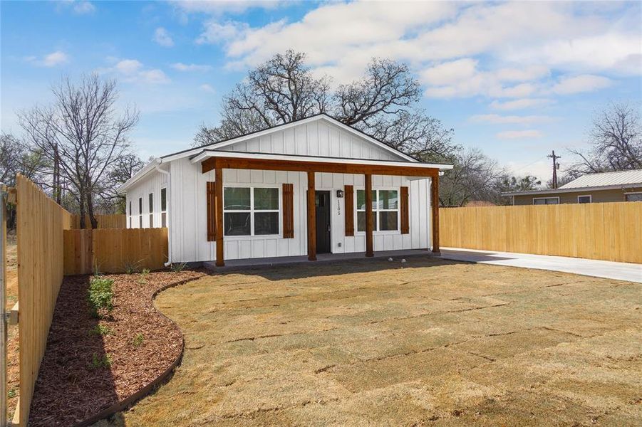 View of front of home featuring covered porch, fence, and board and batten siding View of front of home featuring covered porch, fence, and board and batten siding