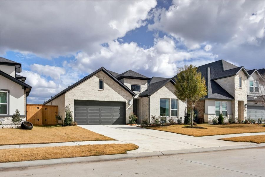 Front exterior of a new home in Trillium, Richmond, TX, highlighting curb appeal (Image 29). Front exterior of a new home in Trillium, Richmond, TX, highlighting curb appeal (Image 29).
