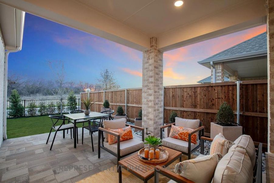 Fenced backyard featuring a patio, outdoor dining area, and an outdoor living space