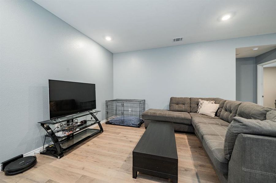 Living room featuring wood finished floors and recessed lighting Living room featuring wood finished floors and recessed lighting