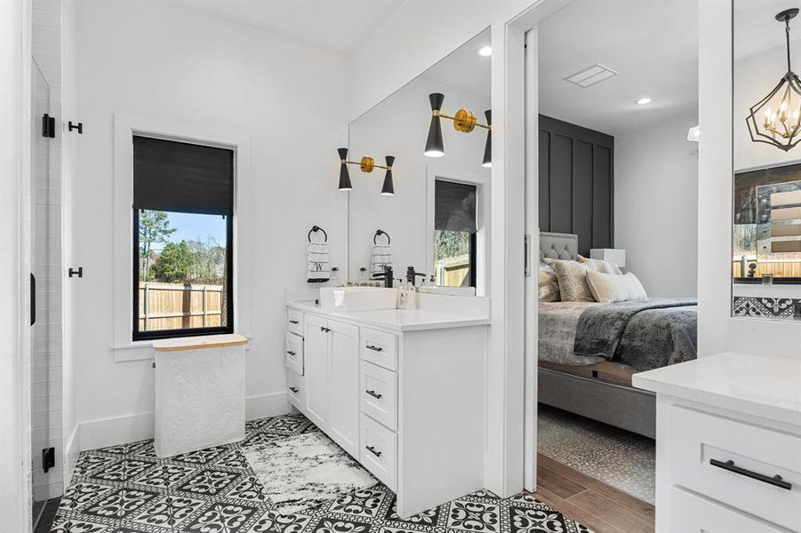 Full bathroom featuring ensuite bathroom, vanity, a chandelier, baseboards, and recessed lighting Full bathroom featuring ensuite bathroom, vanity, a chandelier, baseboards, and recessed lighting