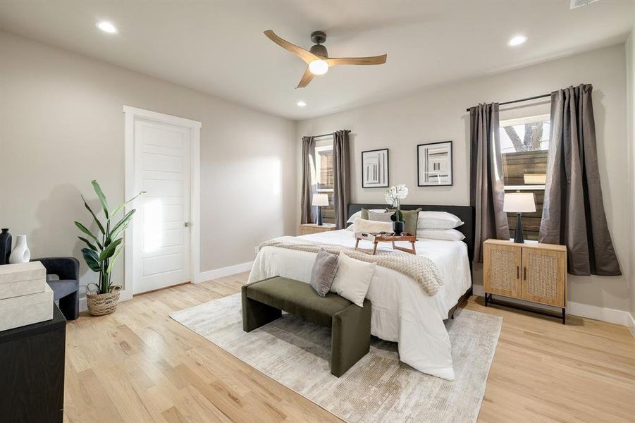 Bedroom featuring ceiling fan and light hardwood / wood-style flooring